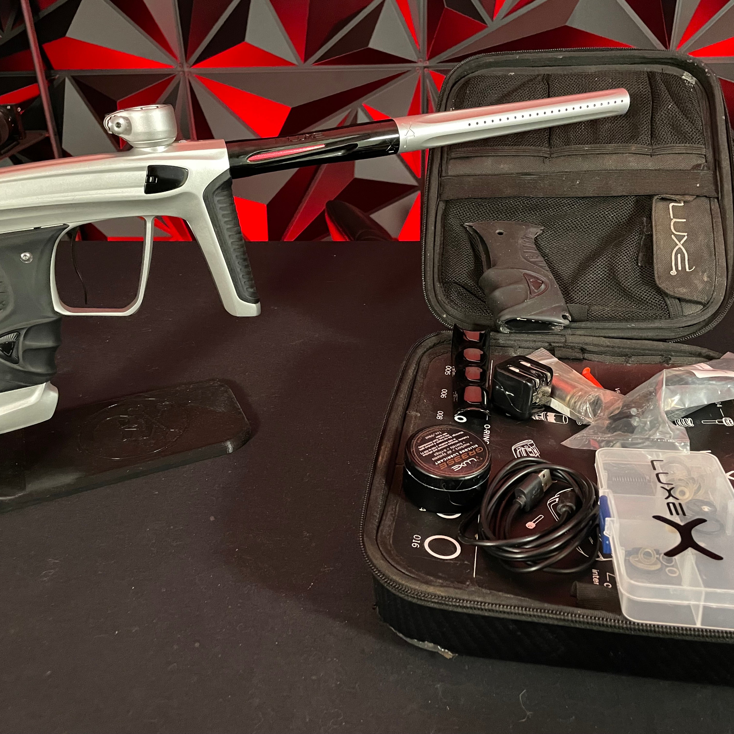 Used DLX Luxe X Paintball Gun - Dust Silver/Polished Black w/Scythe Trigger & Spare Grips