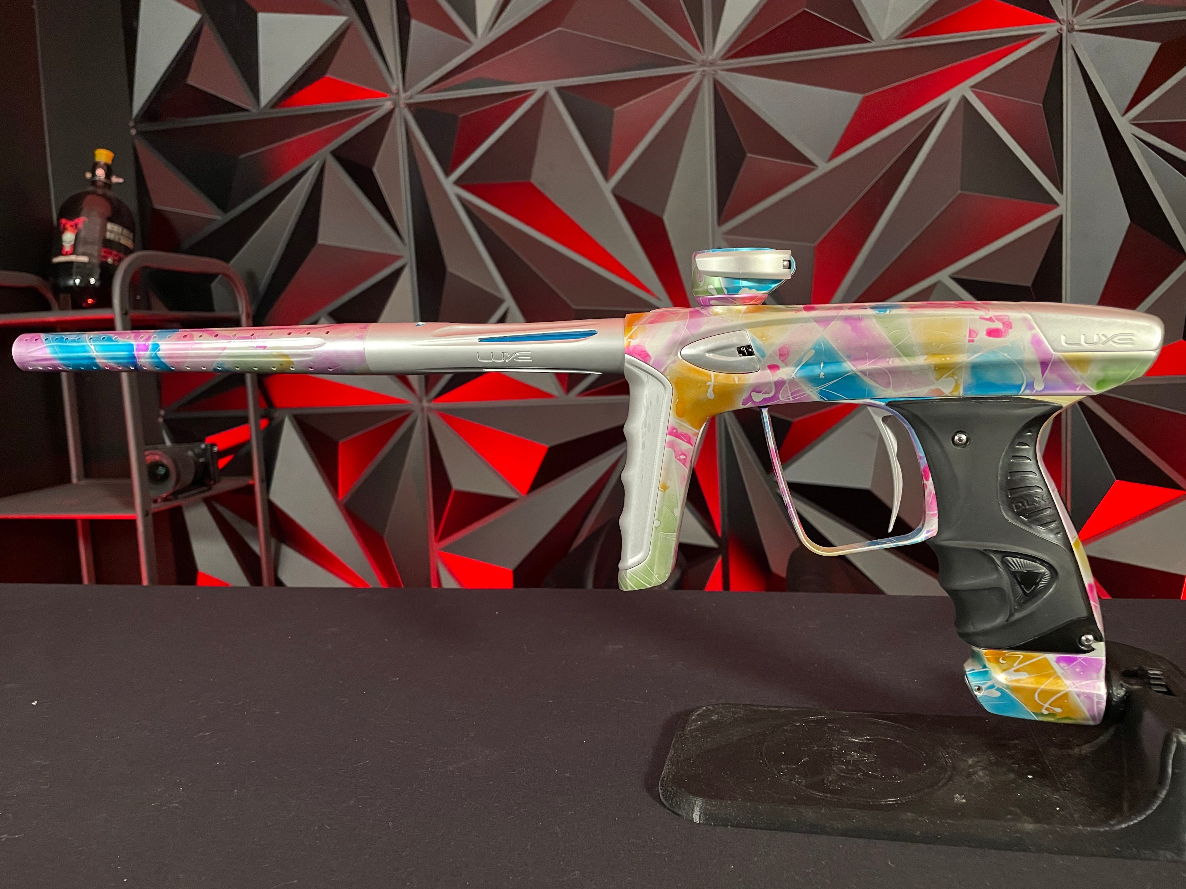 Used DLX Luxe ICE Paintball Gun - Multi-Color Splash w/ 4 Freak Inserts