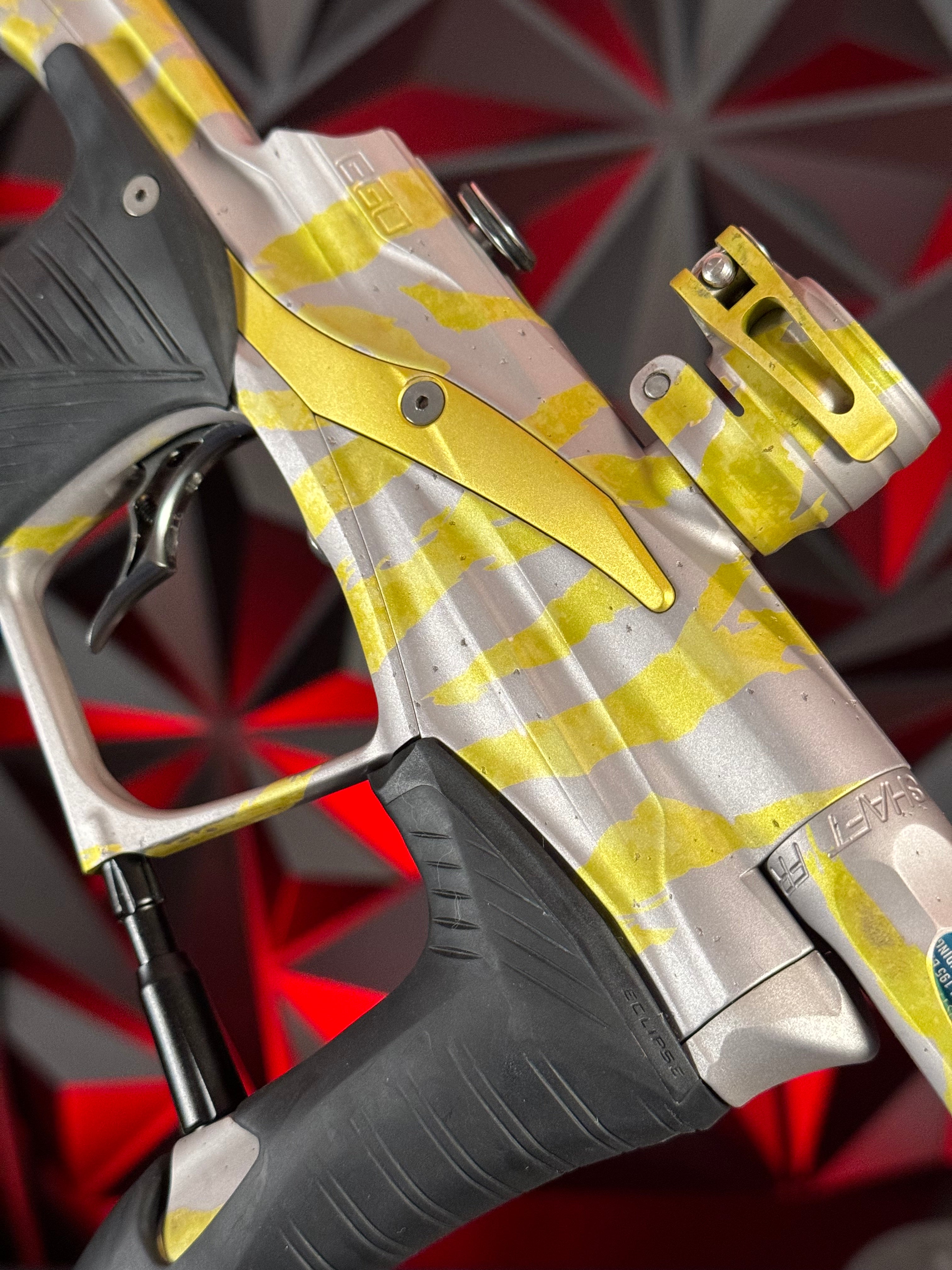 Used Planet Eclipse LV1.1 Paintball Gun - Custom Anno Silver/Yellow Tiger w/Deuce Trigger, TechT Bolt, White & Black Grip Kit