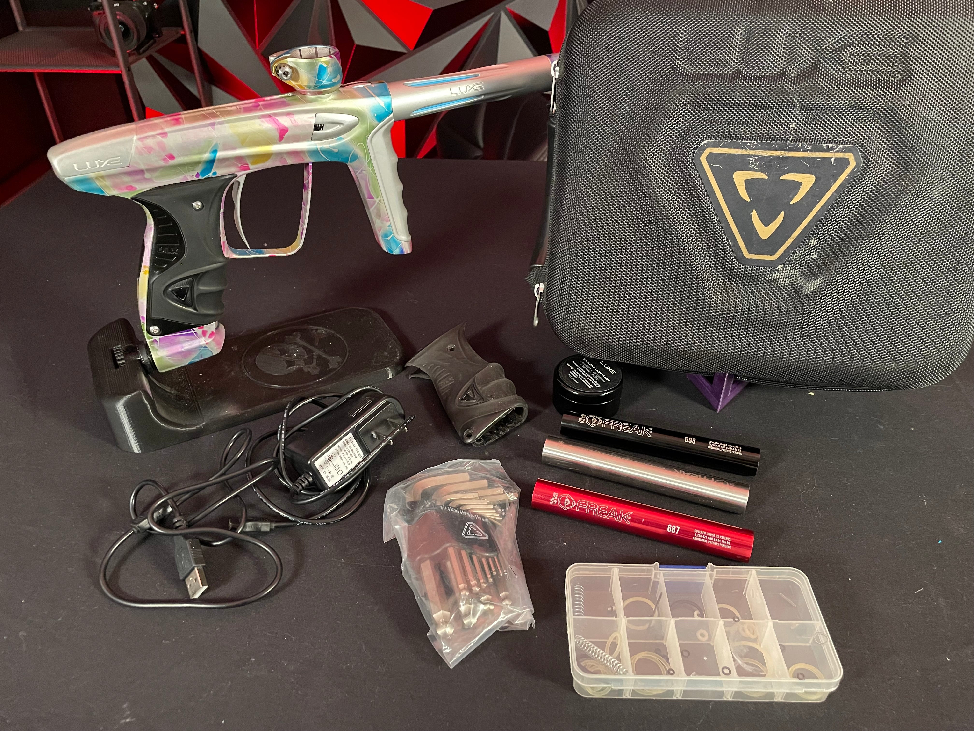 Used DLX Luxe ICE Paintball Gun - Multi-Color Splash w/ 4 Freak Inserts