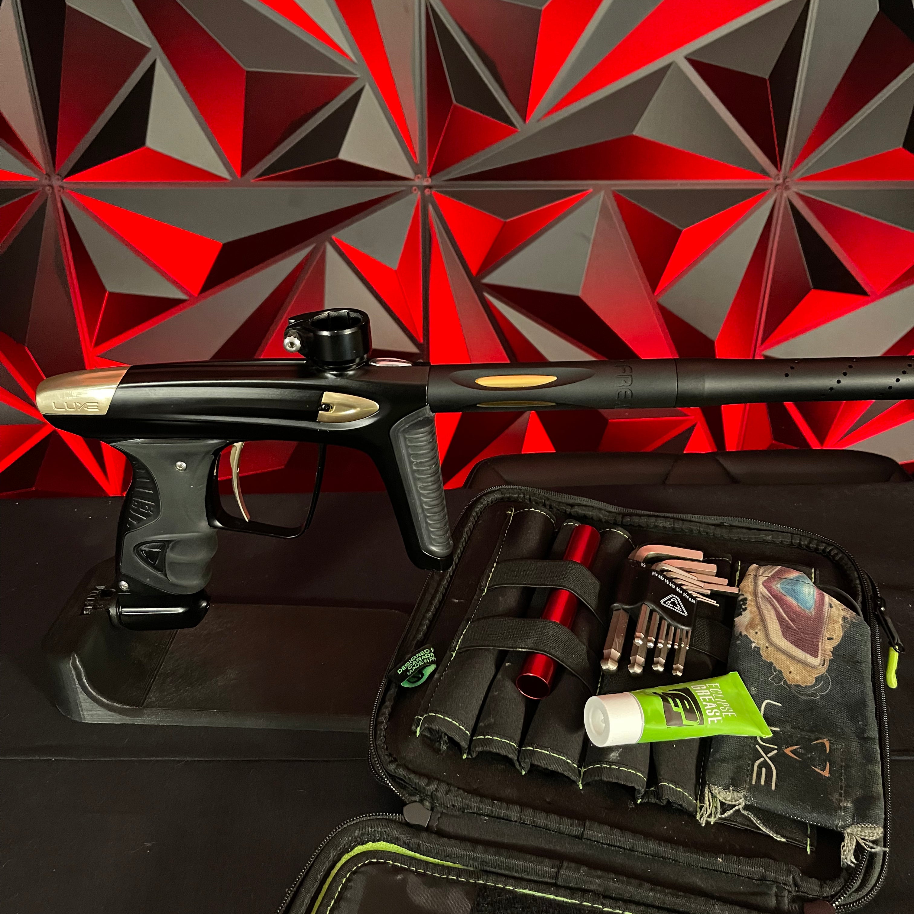 Used DLX Luxe Ice Paintball Gun - Dust Black / Polished Gold w/ Exalt Marker Case