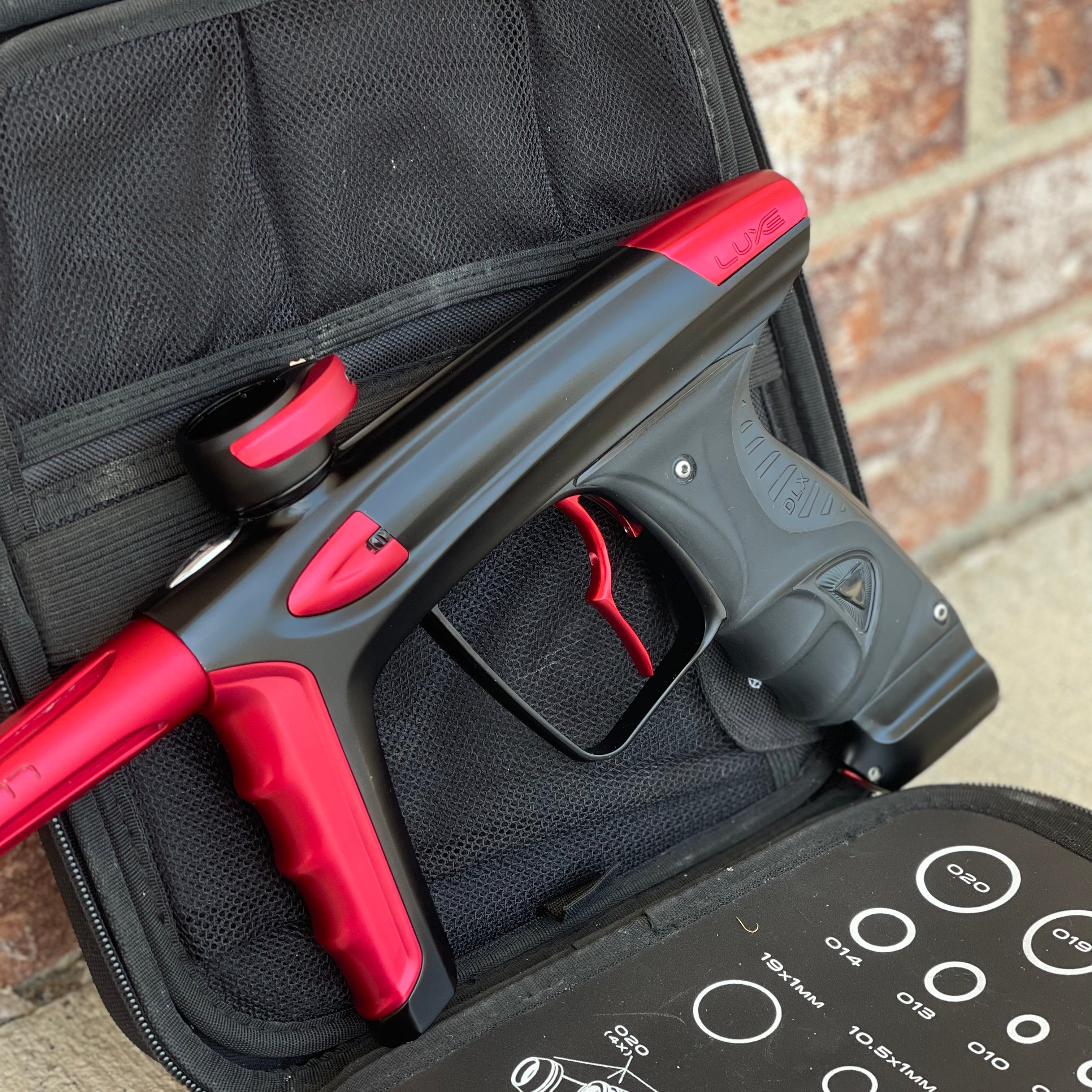 Used DLX Luxe Ice Paintball Gun - Dust Black / Dust Red w/ Infamous Deuce Trigger and 3 Freak Inserts