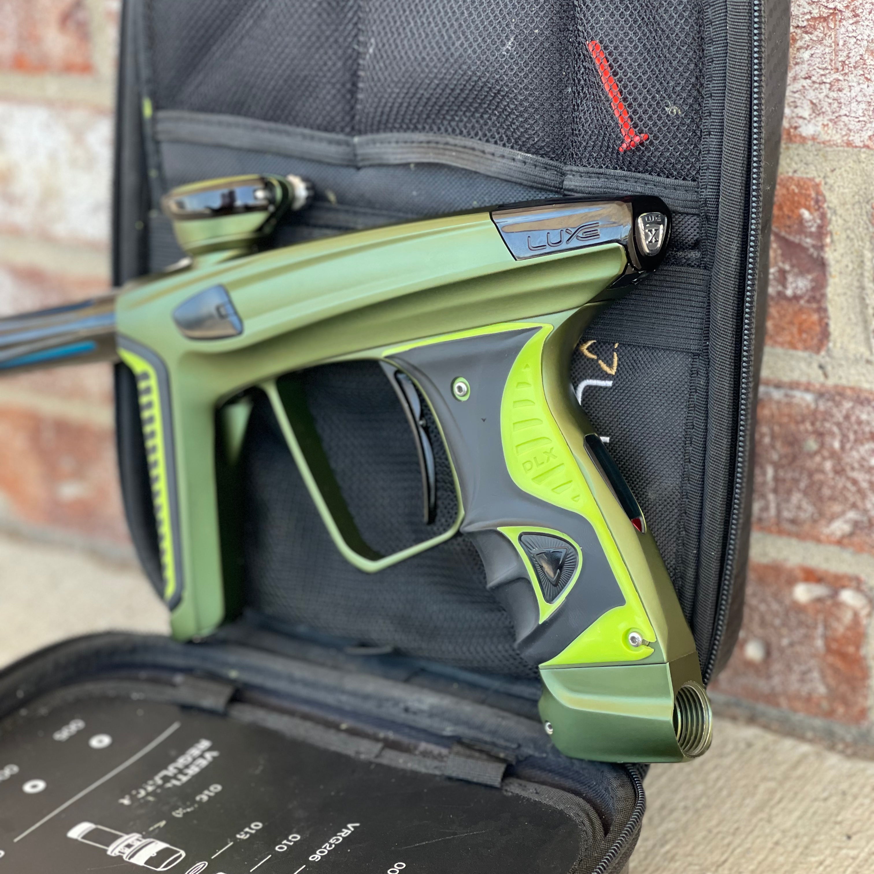 Used DLX Luxe X Paintball Gun - Dust Olive/Polished Black w/ Green Grip Kit