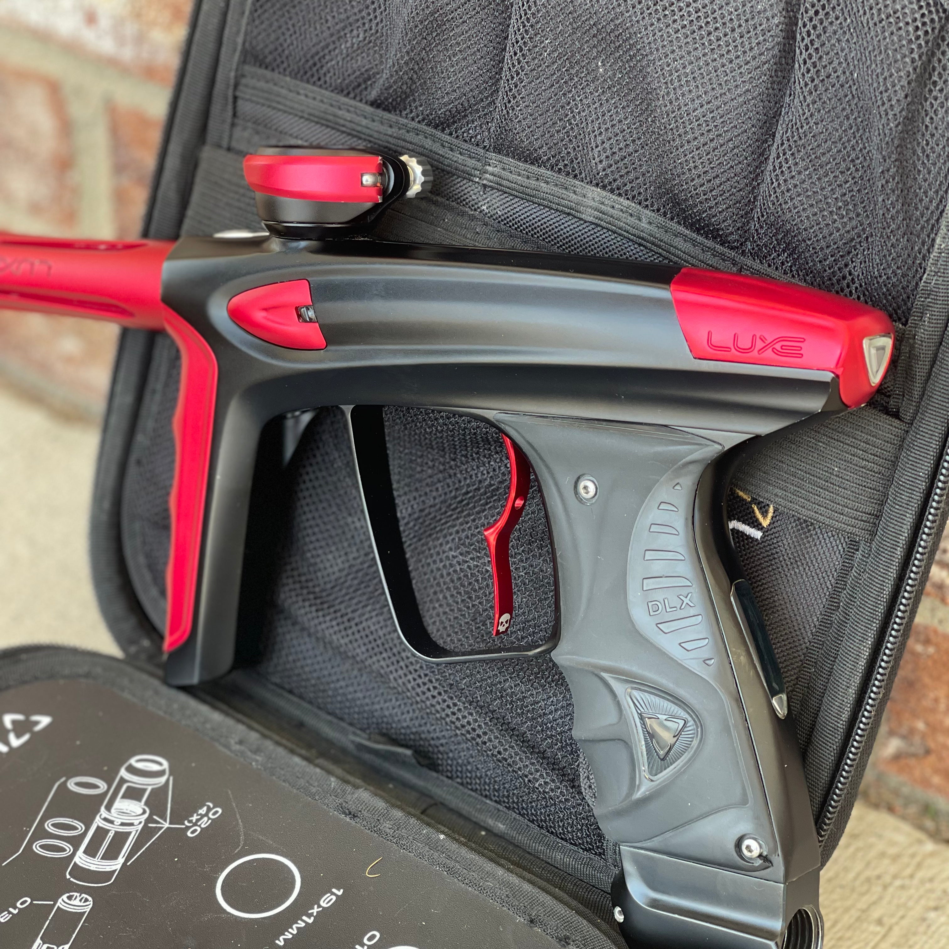 Used DLX Luxe Ice Paintball Gun - Dust Black / Dust Red w/ Infamous Deuce Trigger and 3 Freak Inserts