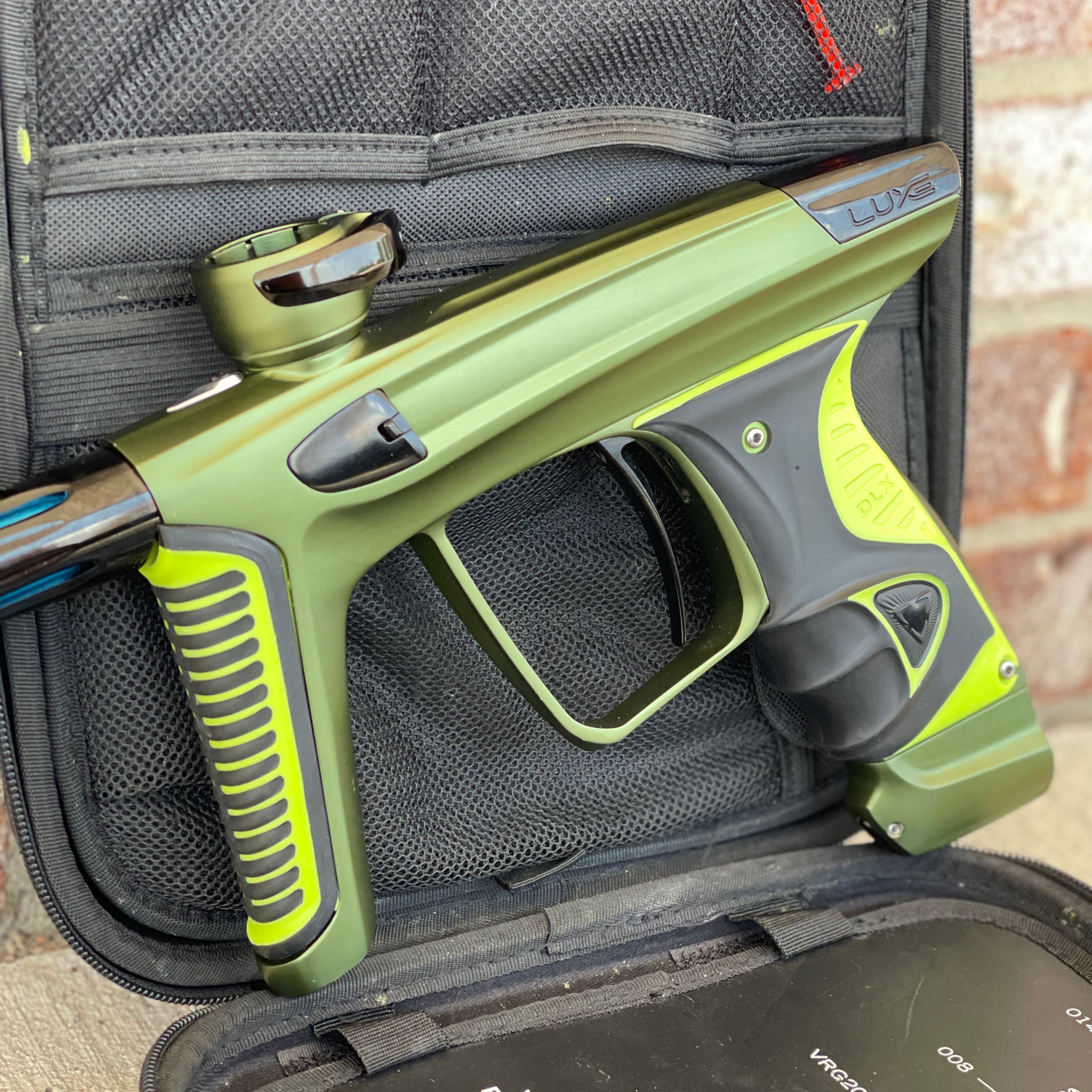 Used DLX Luxe X Paintball Gun - Dust Olive/Polished Black w/ Green Grip Kit