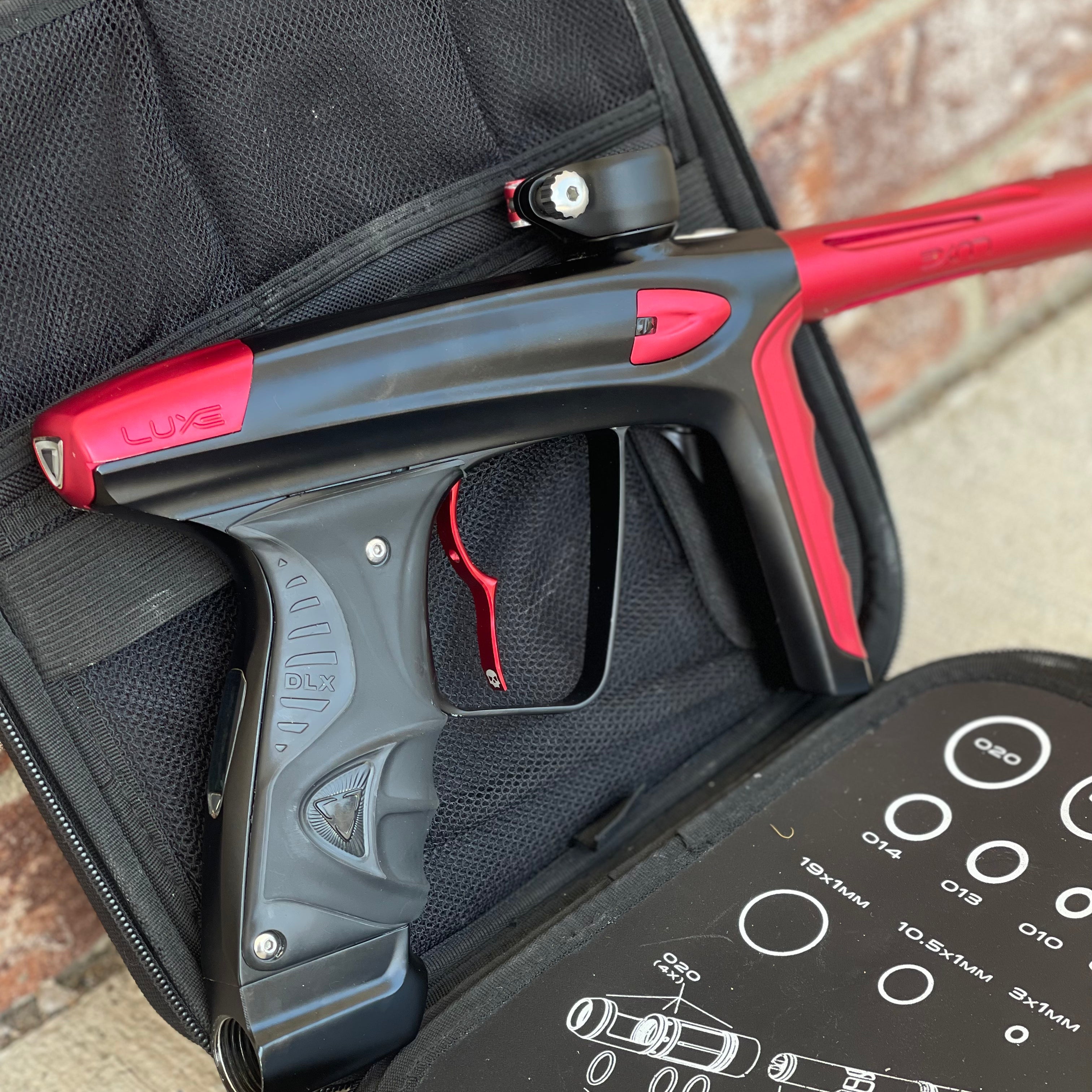 Used DLX Luxe Ice Paintball Gun - Dust Black / Dust Red w/ Infamous Deuce Trigger and 3 Freak Inserts