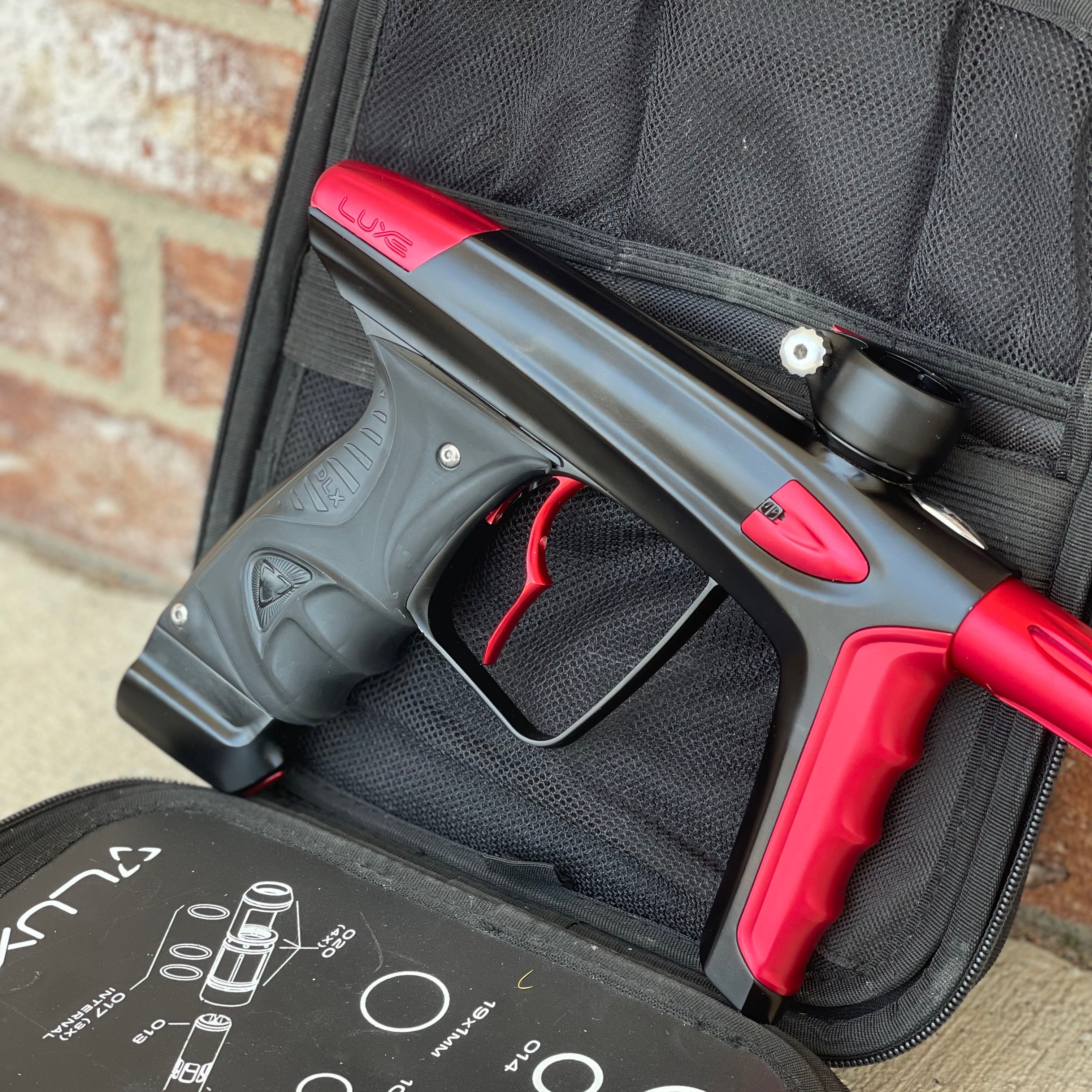 Used DLX Luxe Ice Paintball Gun - Dust Black / Dust Red w/ Infamous Deuce Trigger and 3 Freak Inserts