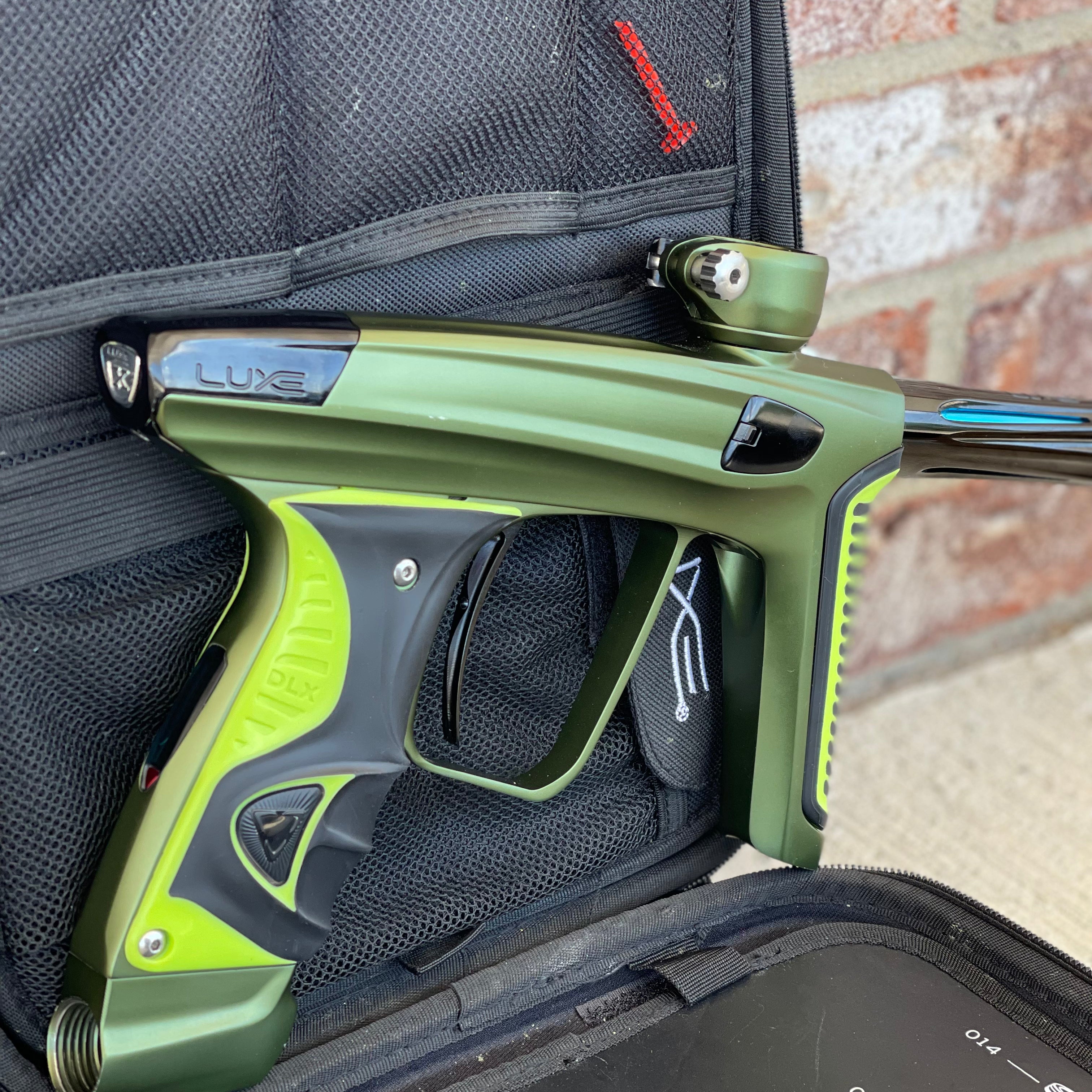 Used DLX Luxe X Paintball Gun - Dust Olive/Polished Black w/ Green Grip Kit