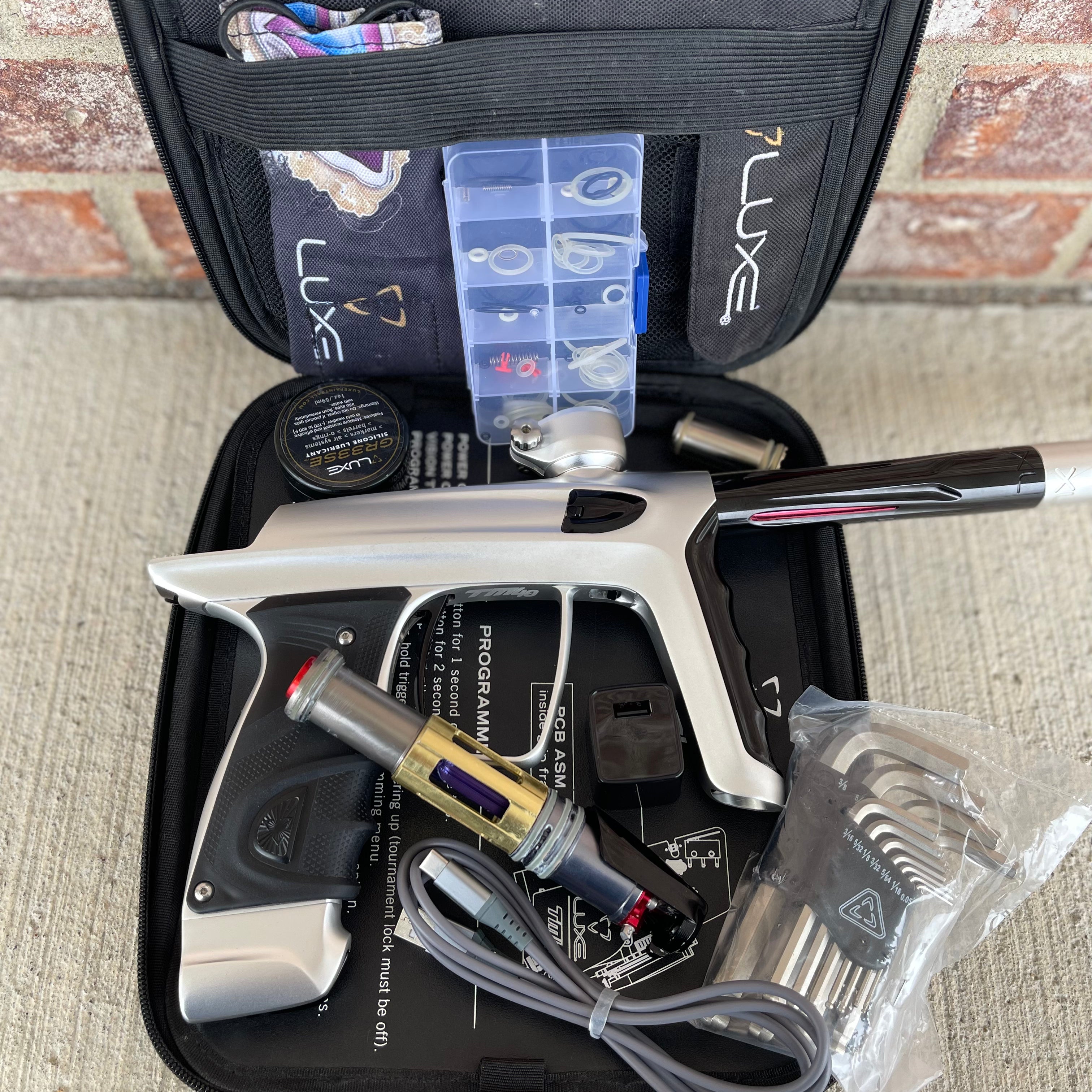 Used DLX Luxe TM40 Paintball Gun - Dust Silver/Gloss Black w/ Stock Bolt and SSC Bolt