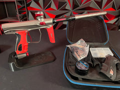 Used Shocker XLS Paintball Gun - Pewter/Red w/ Red Grip Kit