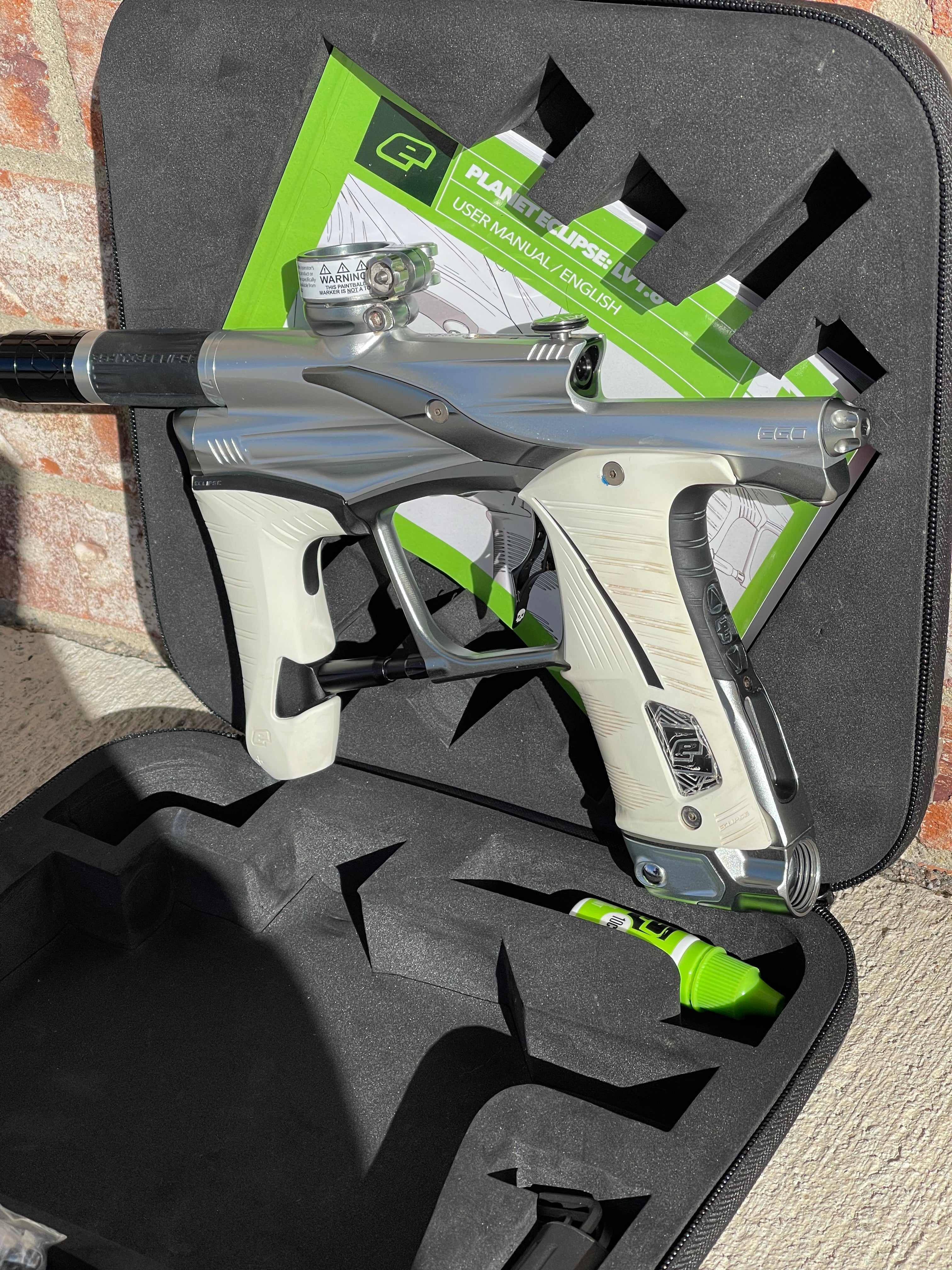 Used Planet Eclipse LV1.6 Paintball Gun - Silver / Dark Grey w/ Infamous Deuce Trigger & White Grip Kit