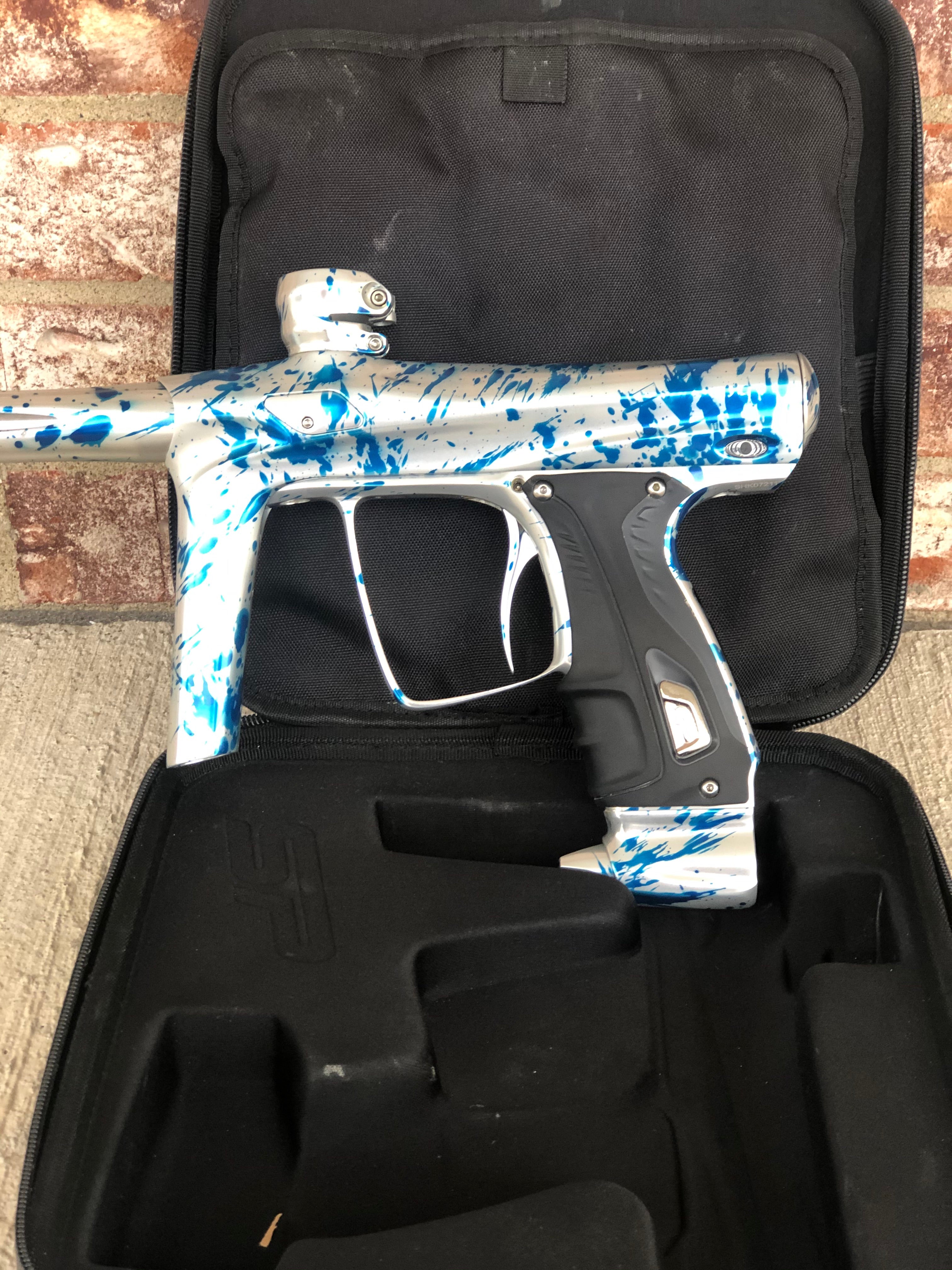 Used SP Shocker RSX Paintball Gun - Silver/Blue Splash