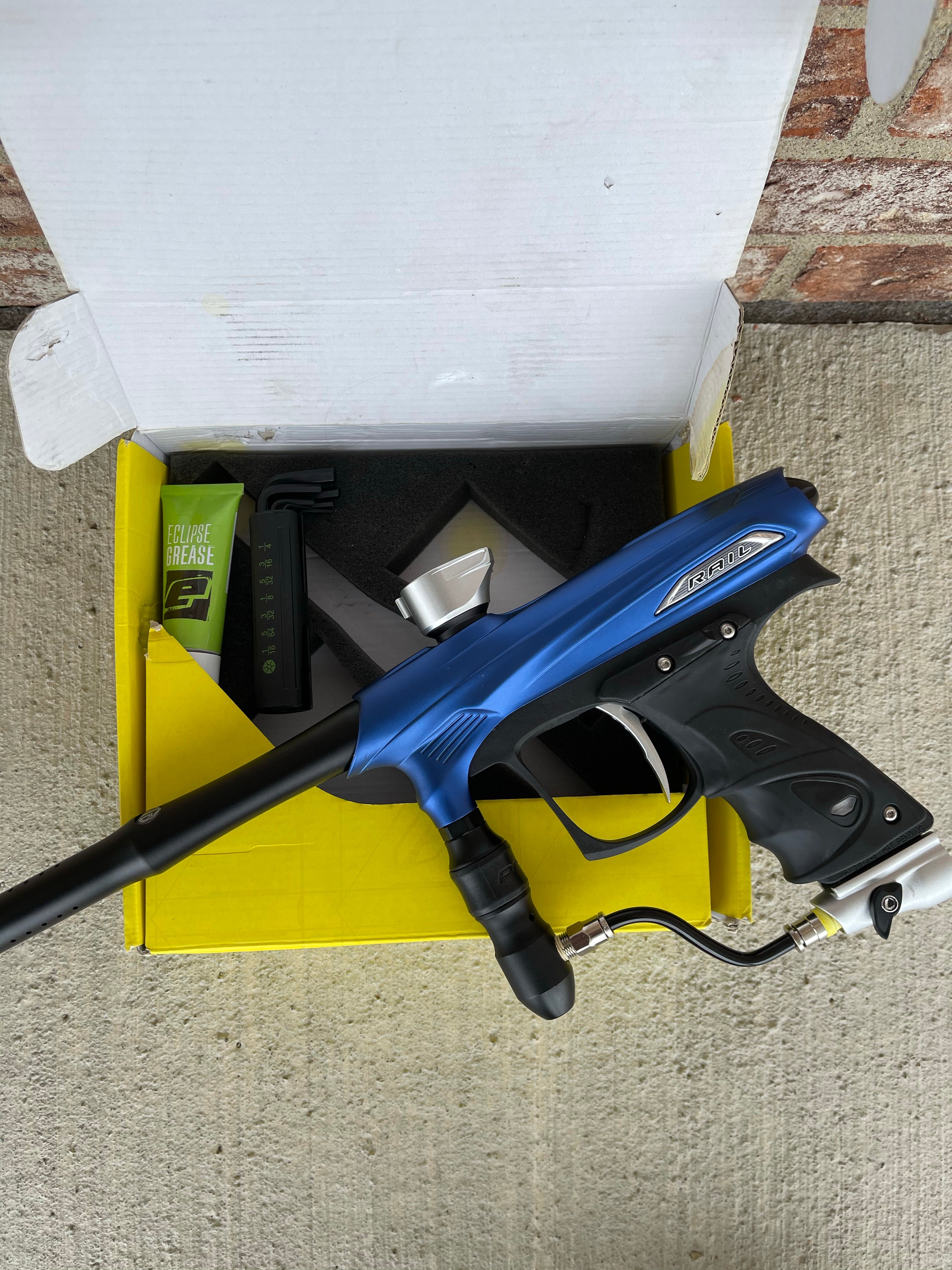 Used Dye Proto Rail Paintball Marker- Blue / Silver / Black