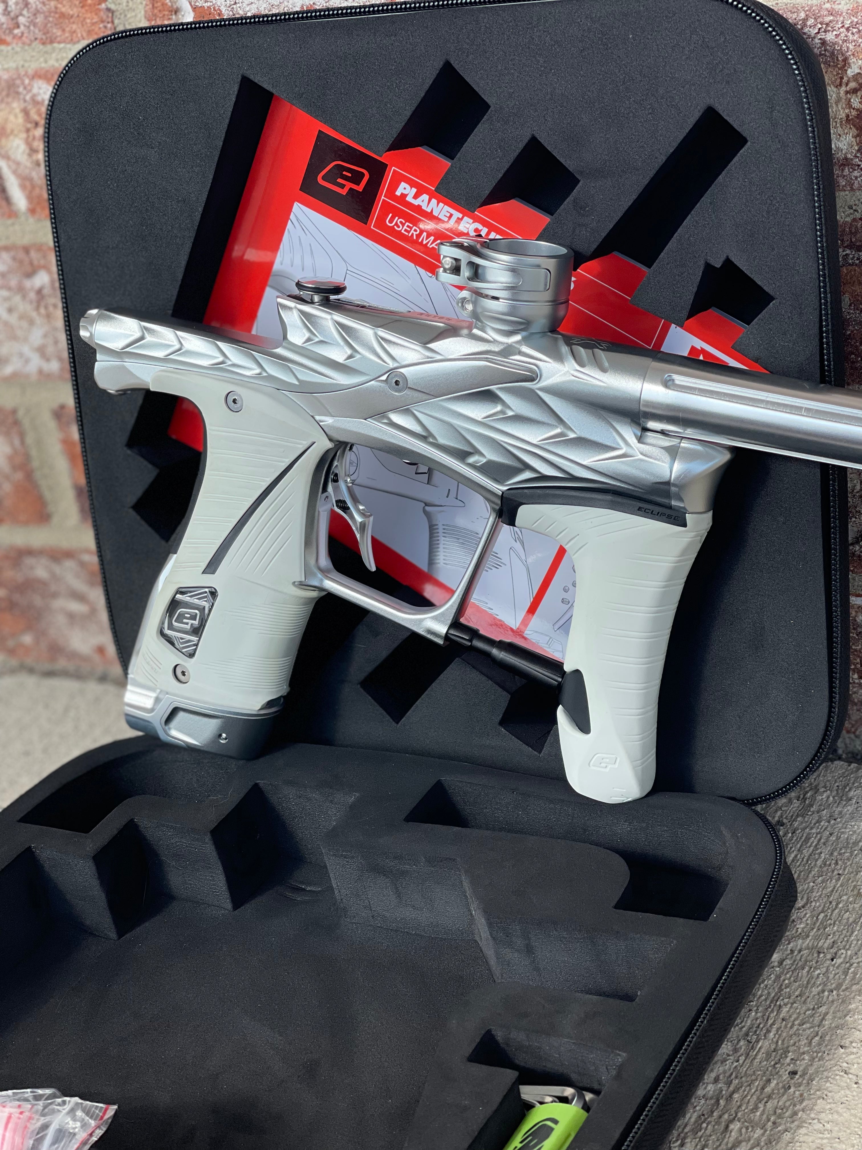 Used Planet Eclipse/HK Army Fossil LV1.6 XV Paintball Gun - Pure (Silver) w/ White and Black Grips, Infamous Silencio Barrel Tip, and Infamous Deuce Trigger