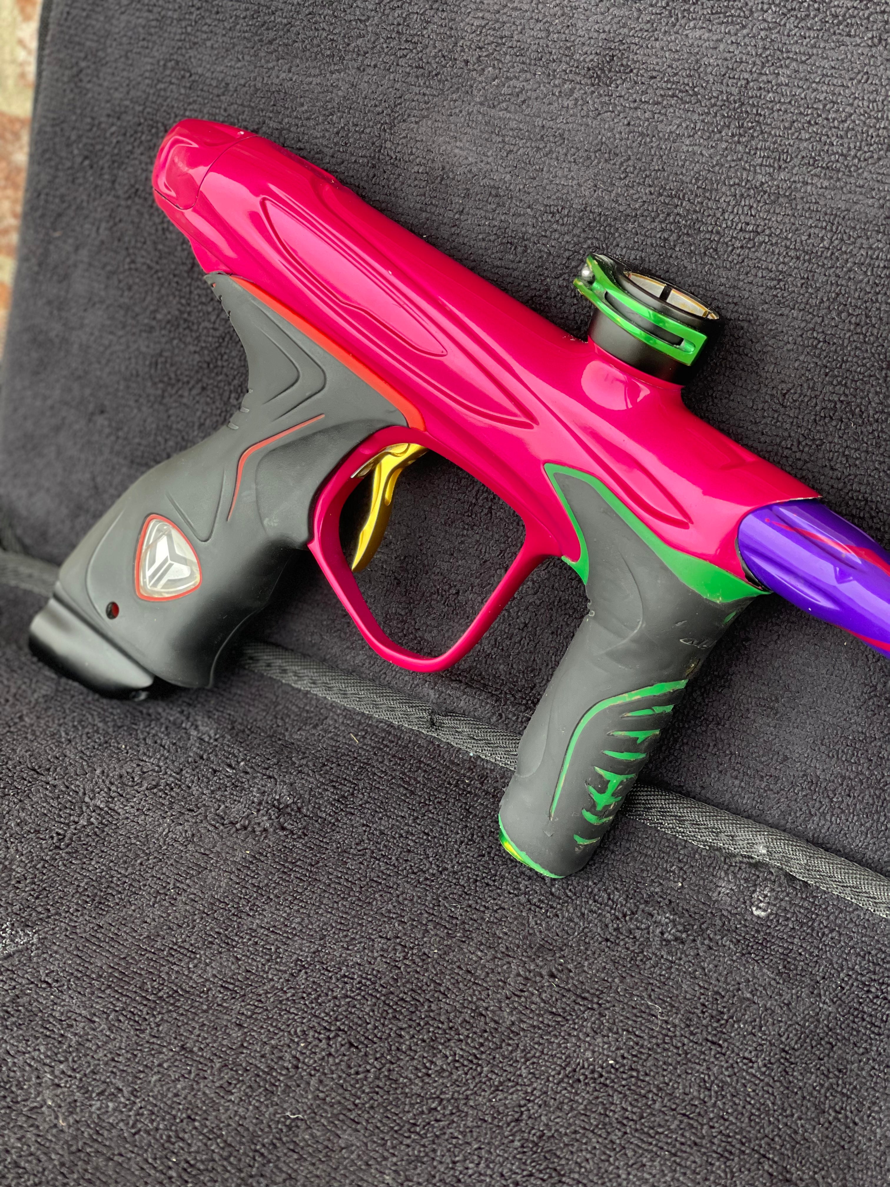 Used Dye M2 Paintball Gun - Pink/Purple/Black/Gold (Spray Paint Collage)