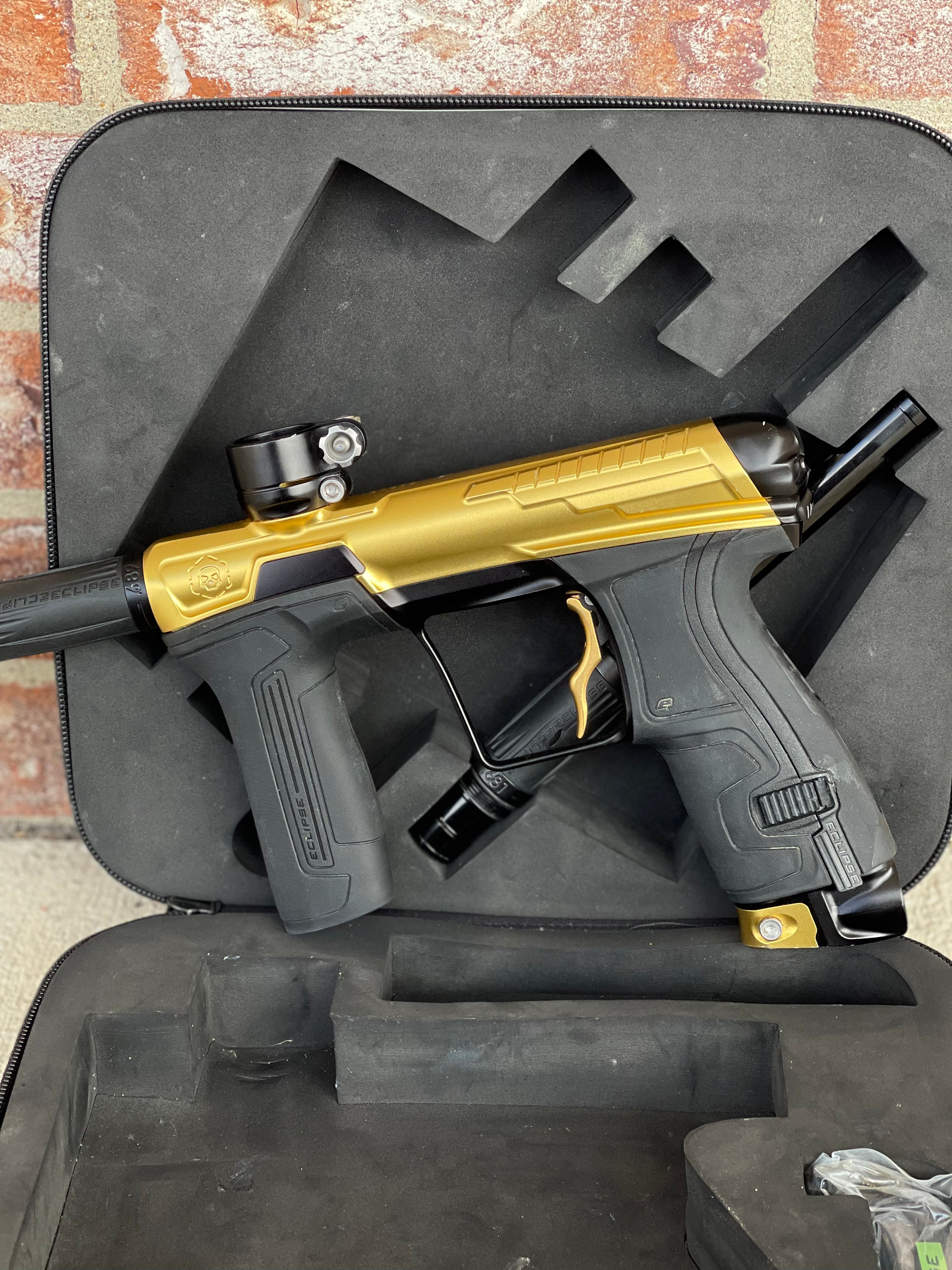 Used Infamous / Planet Eclipse CS2 Paintball Gun - Gold / Black w/ Deuce Trigger & 2 FL Inserts