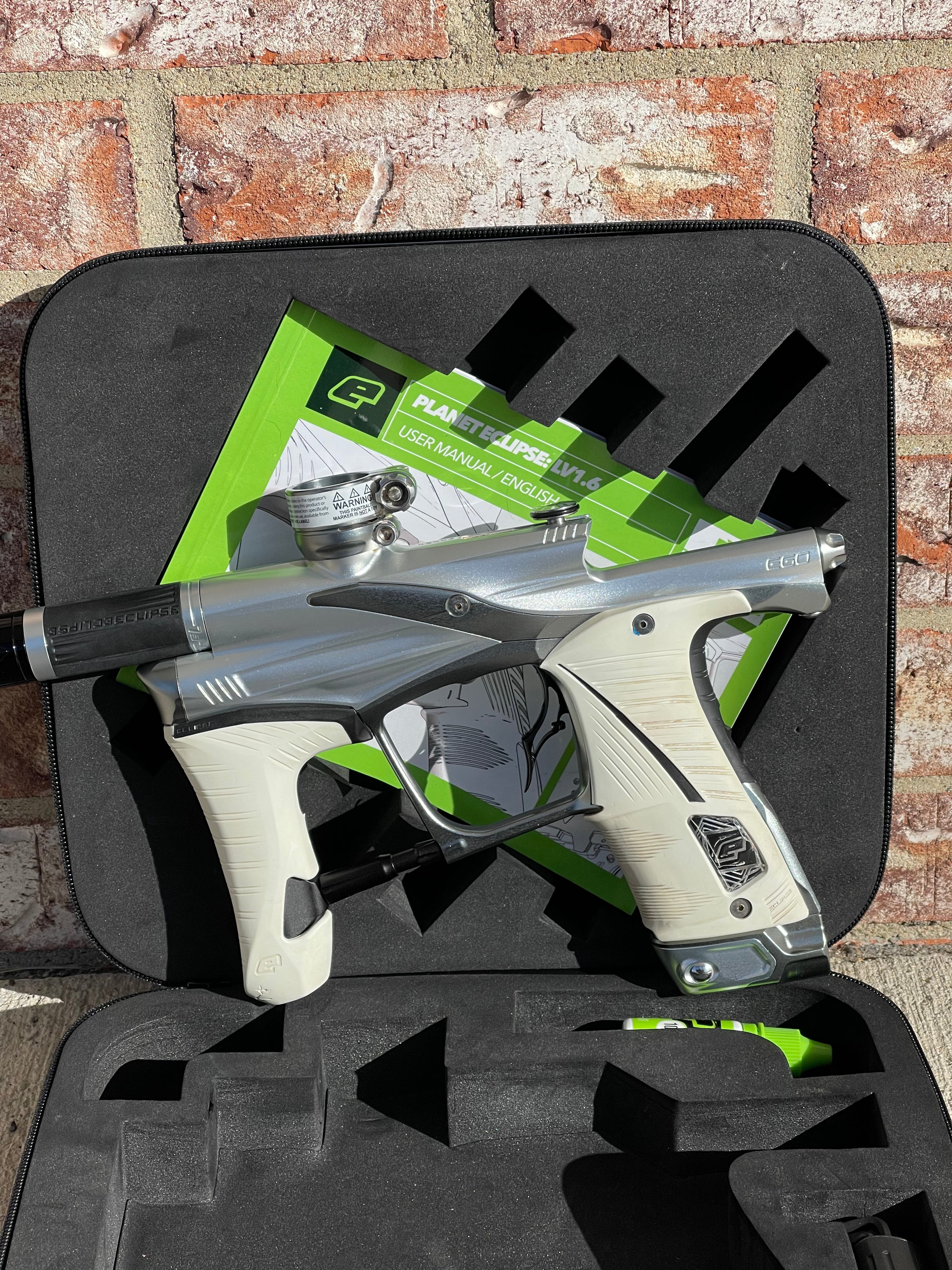 Used Planet Eclipse LV1.6 Paintball Gun - Silver / Dark Grey w/ Infamous Deuce Trigger & White Grip Kit