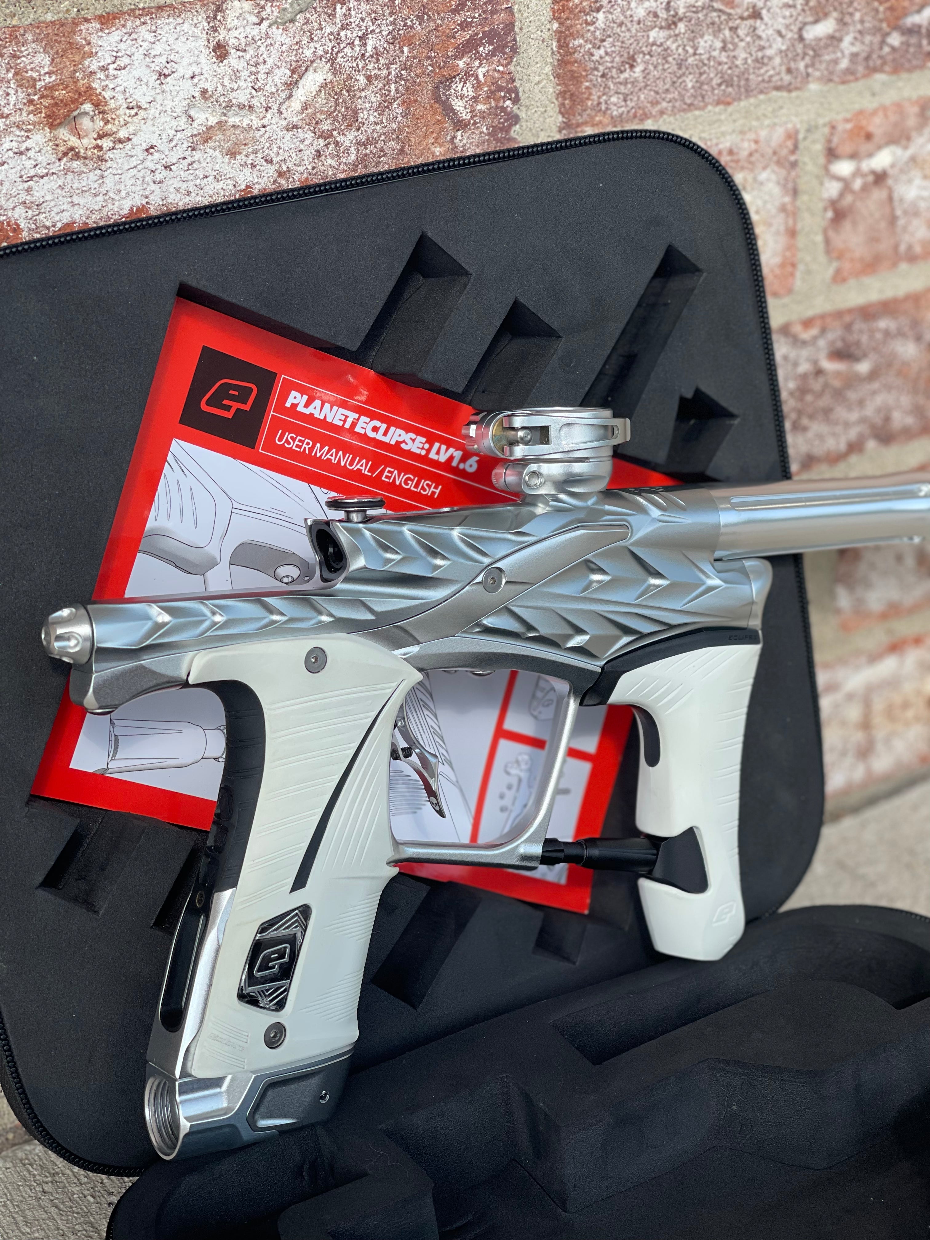 Used Planet Eclipse/HK Army Fossil LV1.6 XV Paintball Gun - Pure (Silver) w/ White and Black Grips, Infamous Silencio Barrel Tip, and Infamous Deuce Trigger