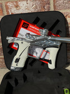 Used Planet Eclipse/HK Army Fossil LV1.6 XV Paintball Gun - Pure (Silver) w/ White and Black Grips, Infamous Silencio Barrel Tip, and Infamous Deuce Trigger