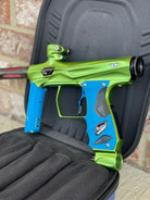 Used Shocker Amp Paintball Gun - Green/Black with Infamous Deuce Trigger and Blue Grips