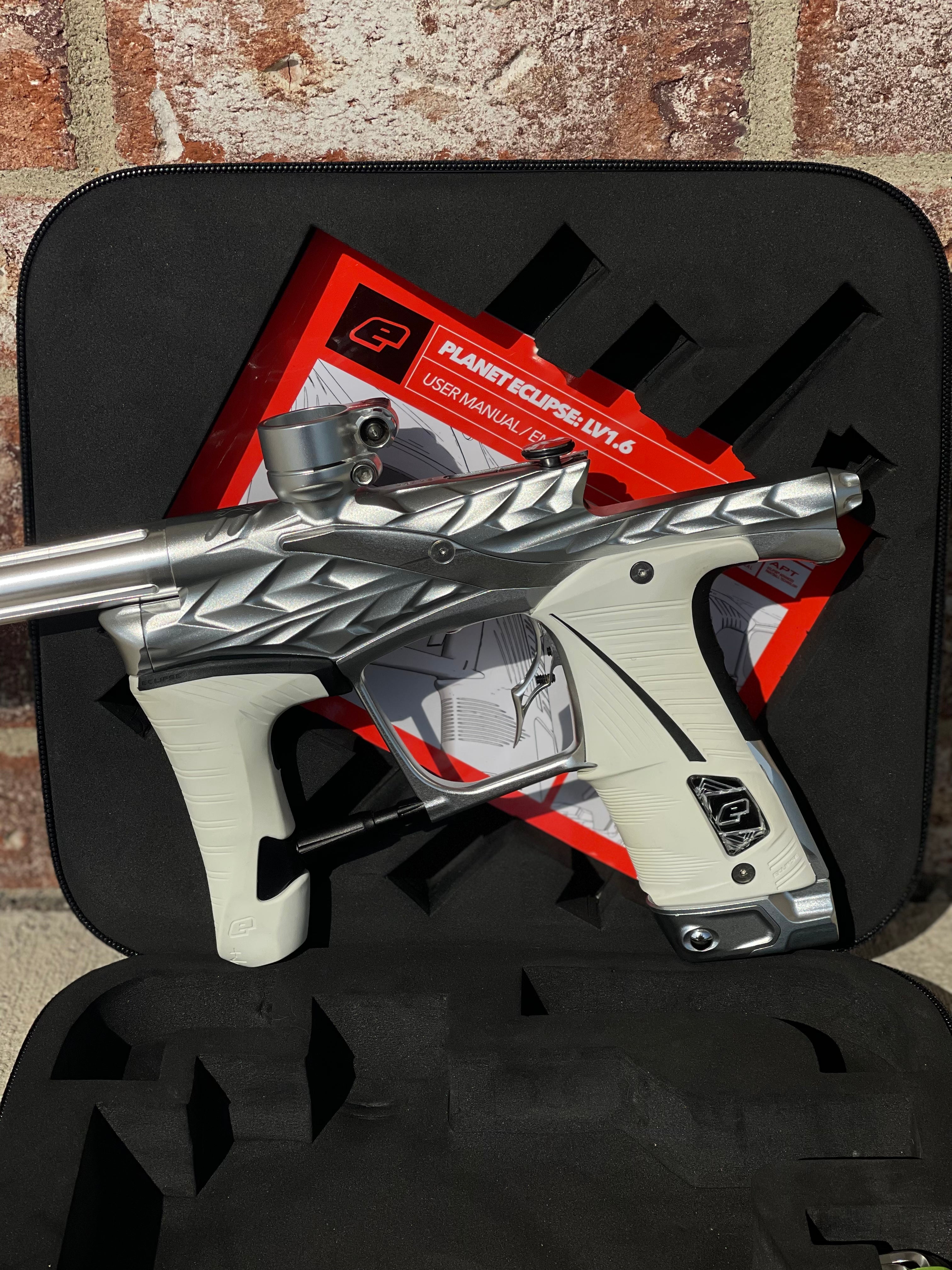 Used Planet Eclipse/HK Army Fossil LV1.6 XV Paintball Gun - Pure (Silver) w/ White and Black Grips, Infamous Silencio Barrel Tip, and Infamous Deuce Trigger