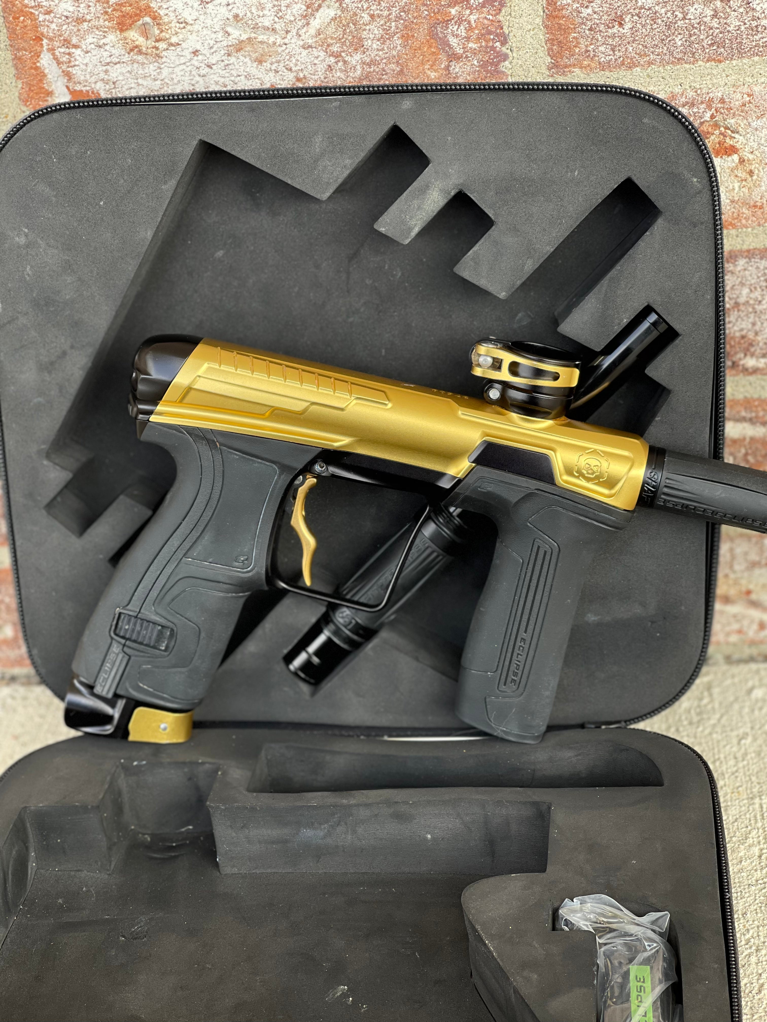 Used Infamous / Planet Eclipse CS2 Paintball Gun - Gold / Black w/ Deuce Trigger & 2 FL Inserts